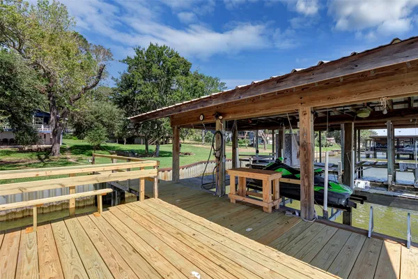 a view of a house with backyard and trees