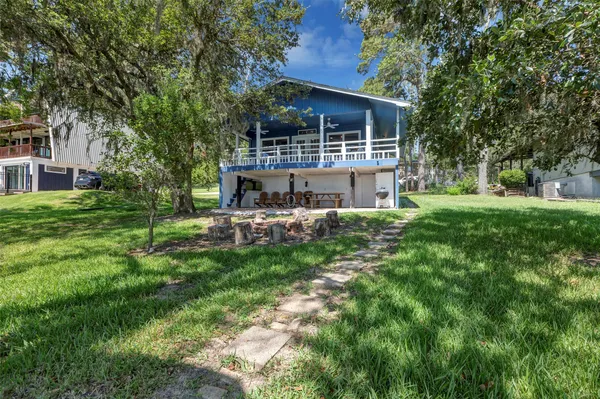 a view of a porch with chairs and table