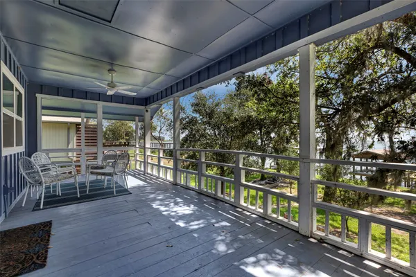 a view of a chairs and table in balcony