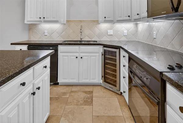 a kitchen with stainless steel appliances granite countertop a sink stove and cabinets