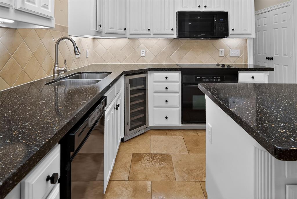 2122 Clear Lake Road Weatherford, TX 76087 - Photo 16 of 40 Built-in wine fridge, microwave, dishwasher and electric range have all the bases covered for your next gathering.