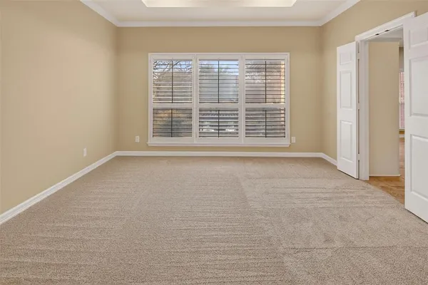 a view of an empty room and closet area
