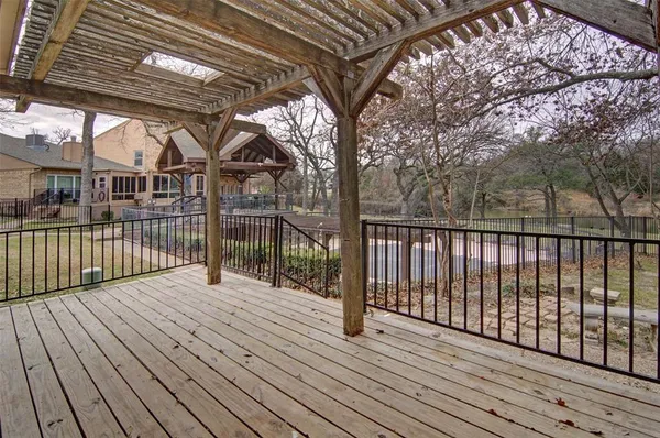 a view of a balcony with lake view and wooden floor