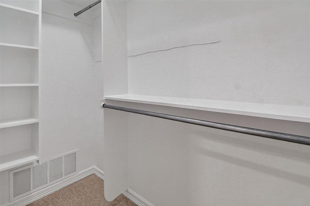 2122 Clear Lake Road Weatherford, TX 76087 - Photo 29 of 40 Second of two walk-in closets with built-in shelves in primary bedroom and bath suite.