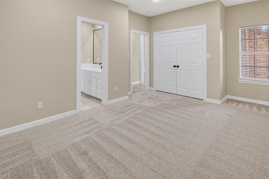 2122 Clear Lake Road Weatherford, TX 76087 - Photo 32 of 40 Second of three bedrooms with a closet with built-in shelves and Hollywood bath.