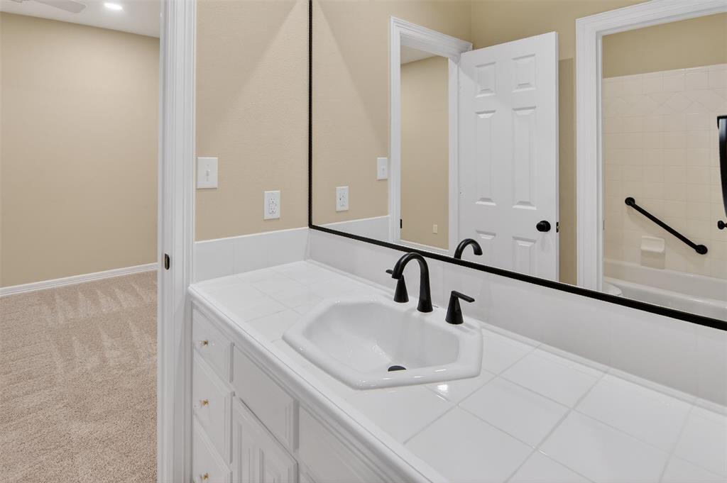 2122 Clear Lake Road Weatherford, TX 76087 - Photo 34 of 40 Hollywood bath between Bedrooms 2 and 3 with nice storage and tub and shower combination.