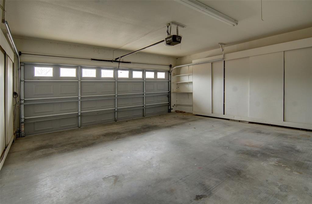 2122 Clear Lake Road Weatherford, TX 76087 - Photo 39 of 40 Ample hidden storage with built-in shelves and space for a second refrigerator in the 2-car garage.