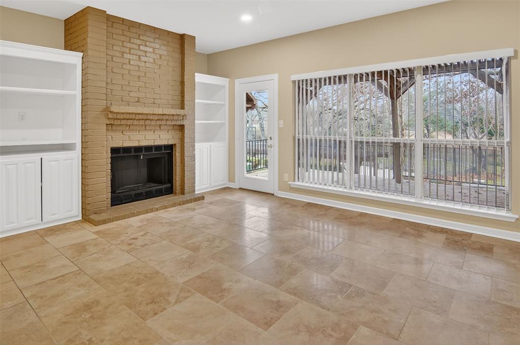 2122 Clear Lake Road Weatherford, TX 76087 - Photo 4 of 40 Family room with wood burning fireplace and built-ins. Wall of windows allows for lots of natural light and a view to the back deck and beyond.
