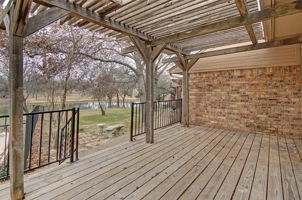 a view of outdoor space with wooden floor and fence