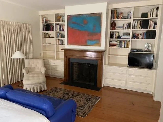 a bedroom with a bed and a lamp on dresser