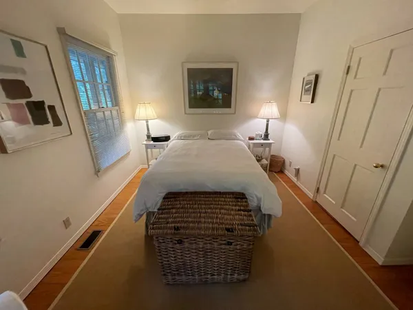 a bathroom with a sink a mirror and a painting on the wall