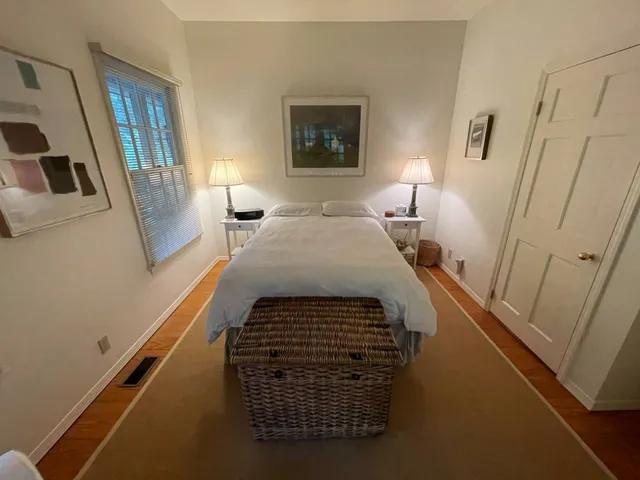 a bathroom with a sink a mirror and a painting on the wall