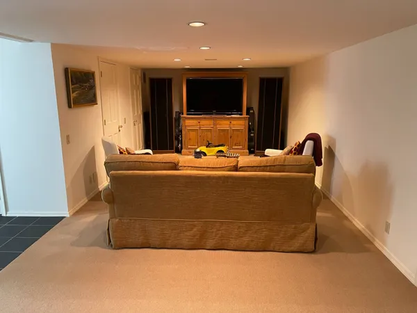 a living room with furniture and a mirror