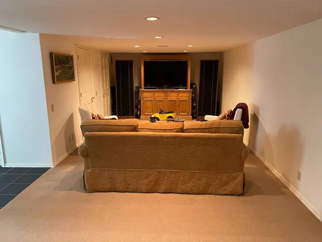 a living room with furniture and a mirror
