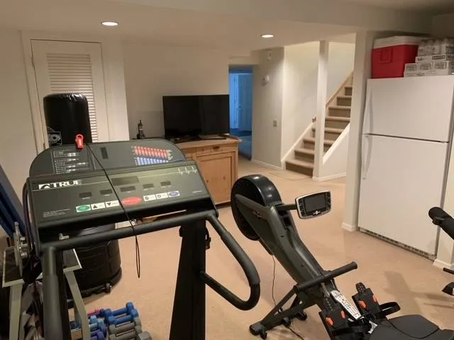 a room with furniture and gym equipment