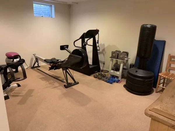 a view of hallway with furniture and a refrigerator
