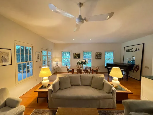 a living room filled with furniture hardwood floor and a table