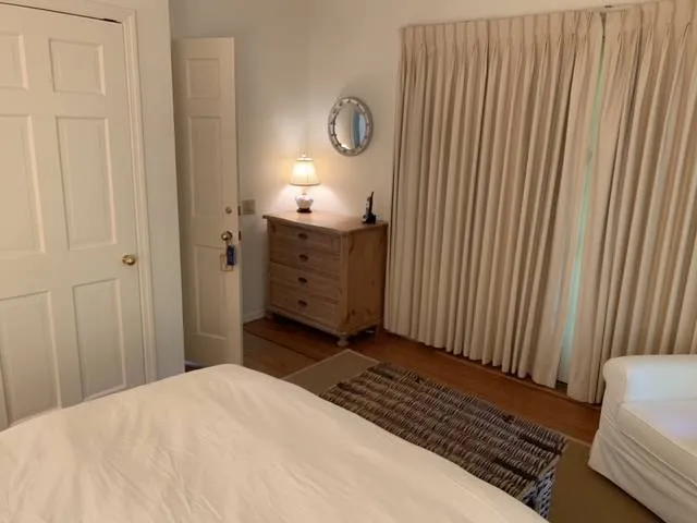 a bedroom with a bed and flat screen tv