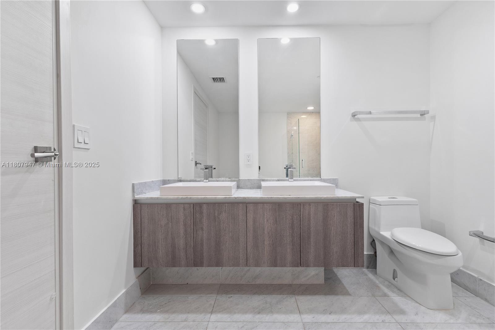 801 South Miami Avenue, Unit 2201 Miami, FL 33131 - Photo 25 of 37 a bathroom with a sink a toilet and shower