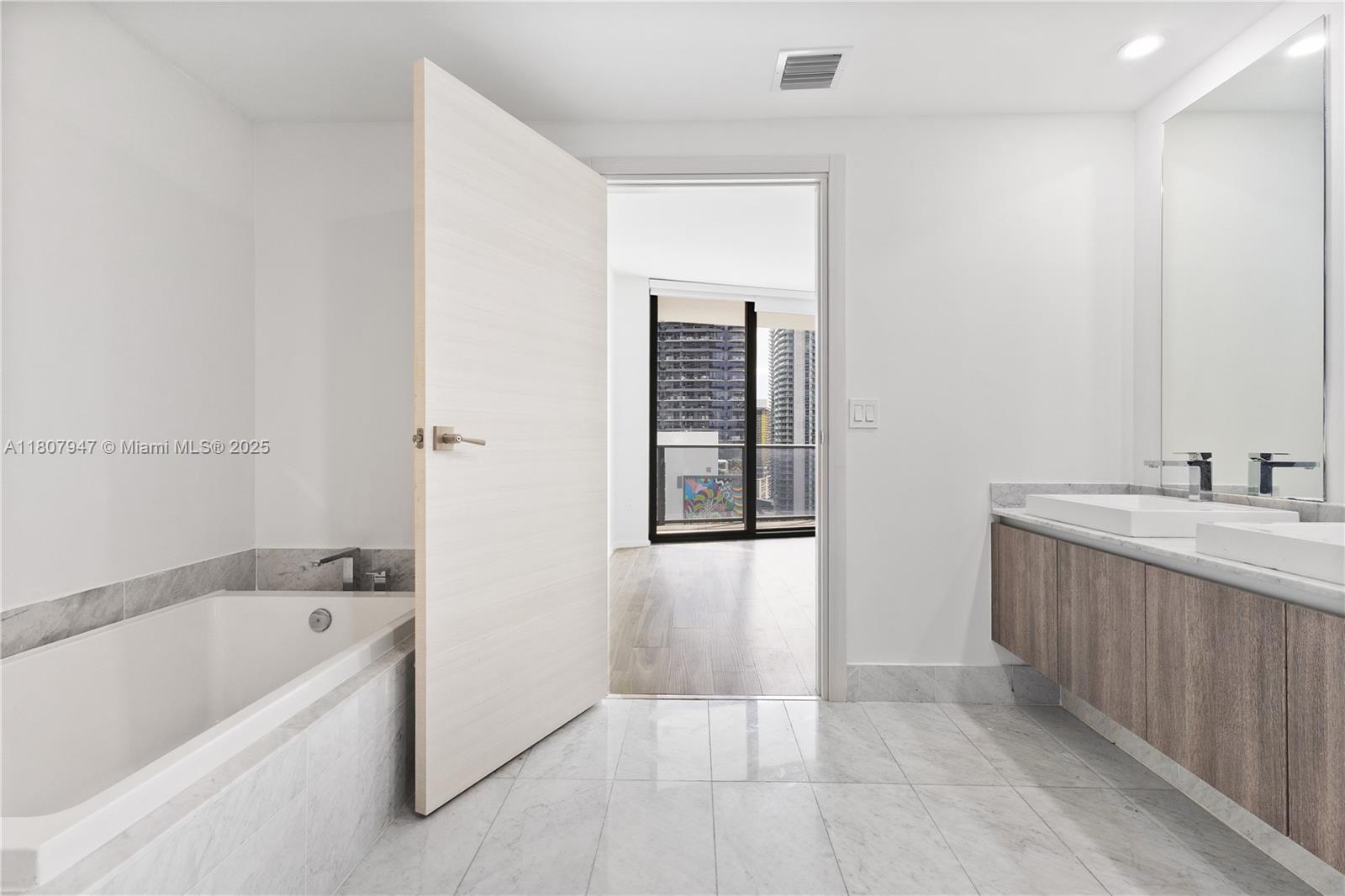801 South Miami Avenue, Unit 2201 Miami, FL 33131 - Photo 26 of 37 a bathroom with a bathtub and a sink