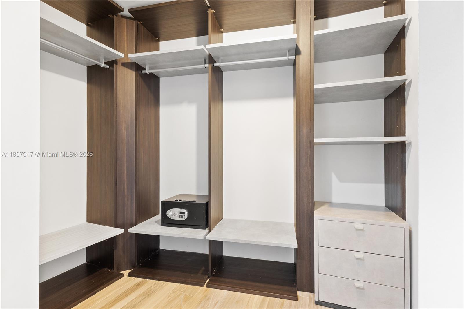 801 South Miami Avenue, Unit 2201 Miami, FL 33131 - Photo 27 of 37 a view of walk in closet with empty racks