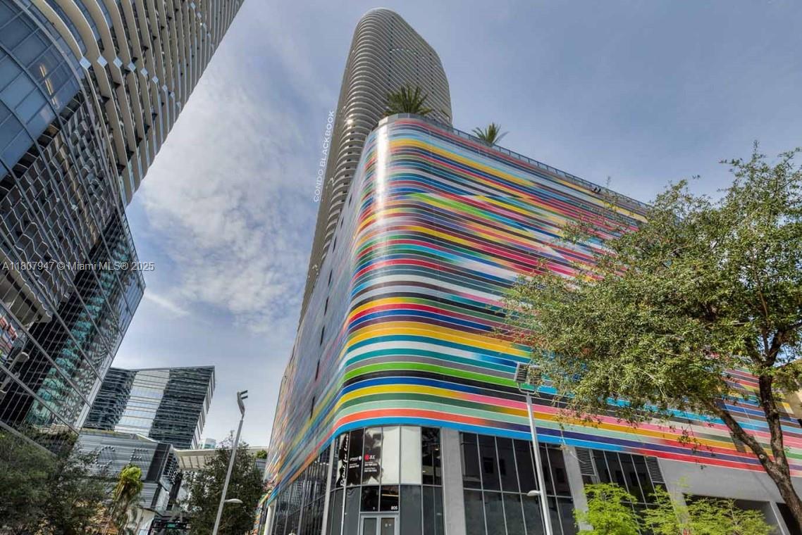 801 South Miami Avenue, Unit 2201 Miami, FL 33131 - Photo 5 of 37 a front view of a multi story residential apartment building with yellow space