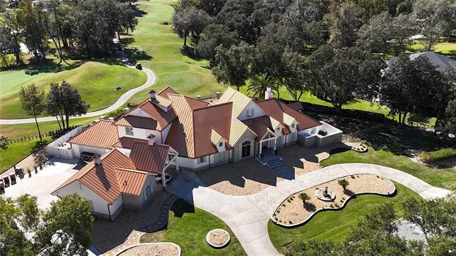 an aerial view of residential house with outdoor space and swimming pool