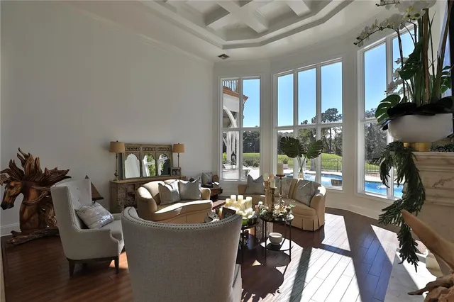 a living room with furniture and a floor to ceiling window