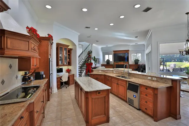 a kitchen with stainless steel appliances kitchen island granite countertop a sink and cabinets