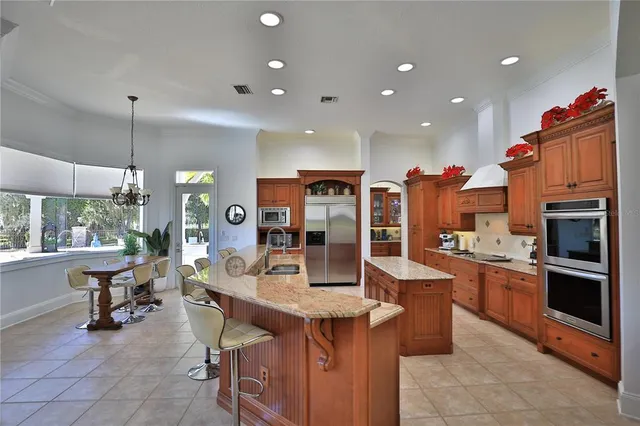 a kitchen with a dining table chairs and refrigerator