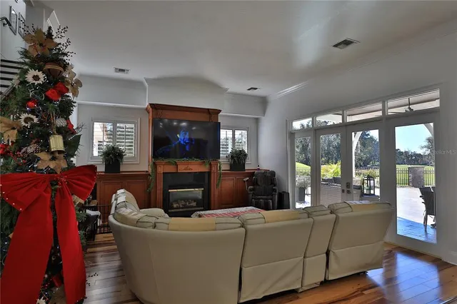 a room with lots of wooden furniture and a dining table