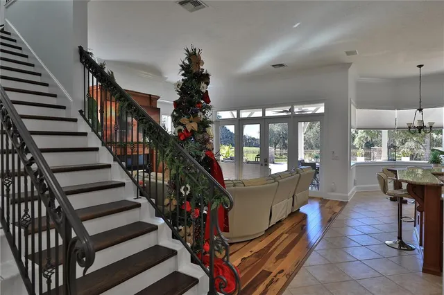 a bedroom with a large bed and a chandelier