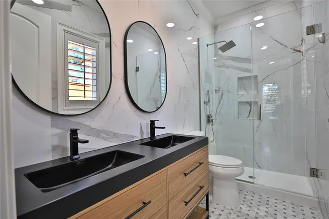 a bathroom with a shower sink and mirror