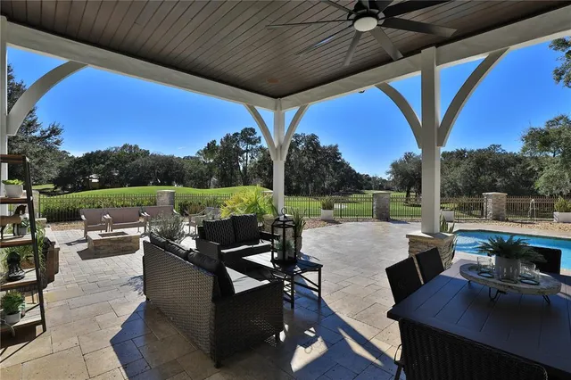 a living room with furniture a fireplace and potted plants