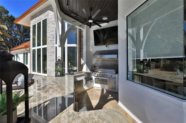 a view of a patio with couches and a table and chairs under an umbrella