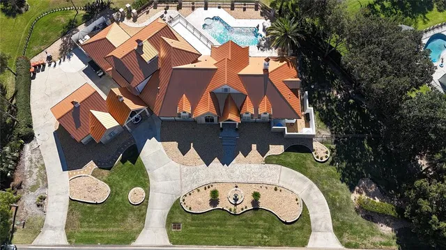 an aerial view of a house swimming pool and outdoor seating