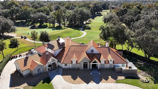 an aerial view of house with yard swimming pool and outdoor seating