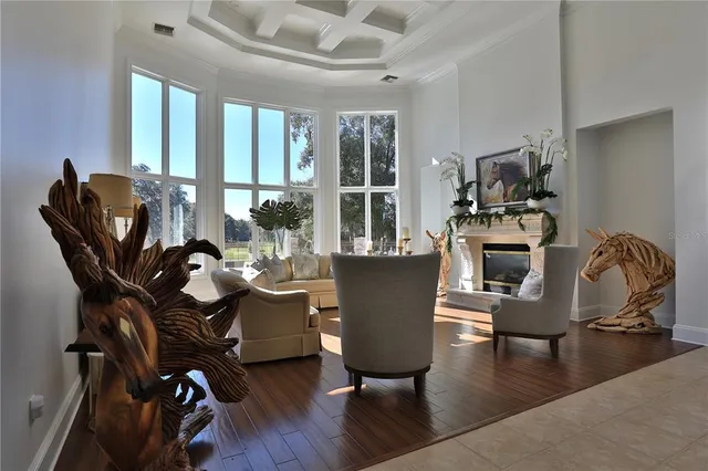 a dining room with furniture a chandelier and wooden floor