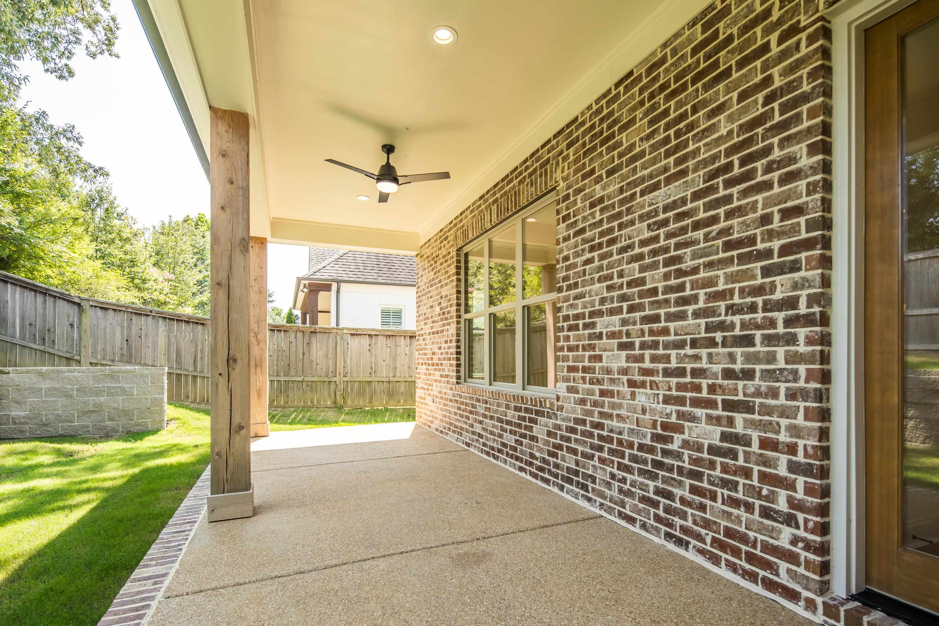 3406 Village Cross Loop Collierville, TN 38017 - Photo 37 of 40 Covered patio featuring an exposed aggregate concrete surface, a ceiling fan, recessed lighting, and a brick exterior