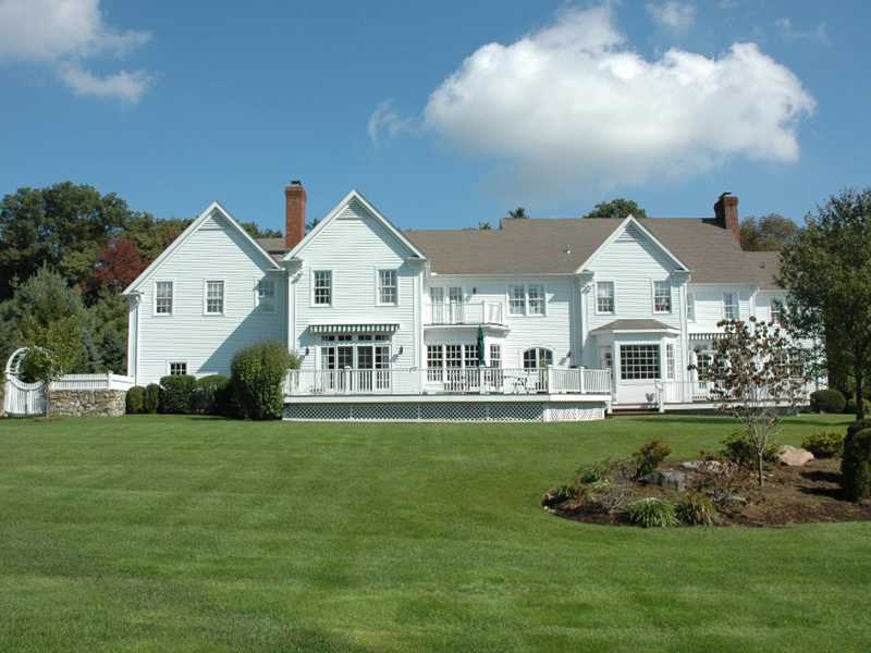 359 Mansfield Avenue Darien, CT 06820 - Photo 21 of 25 a front view of a house with a garden and trees