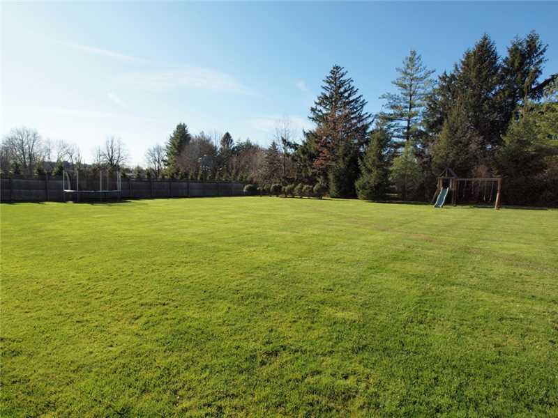 359 Mansfield Avenue Darien, CT 06820 - Photo 23 of 25 a view of a field with an trees in the background
