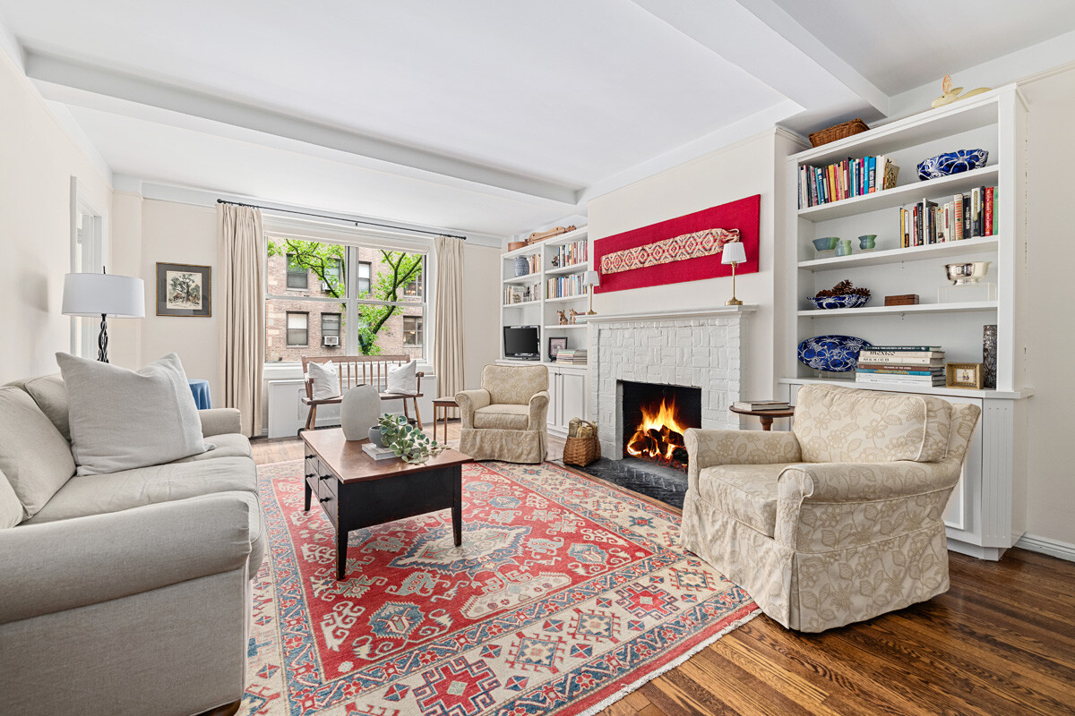 215 East 73rd Street, Unit 2A Manhattan, NY 10021 - Photo 1 of 20 a living room with furniture and a fireplace