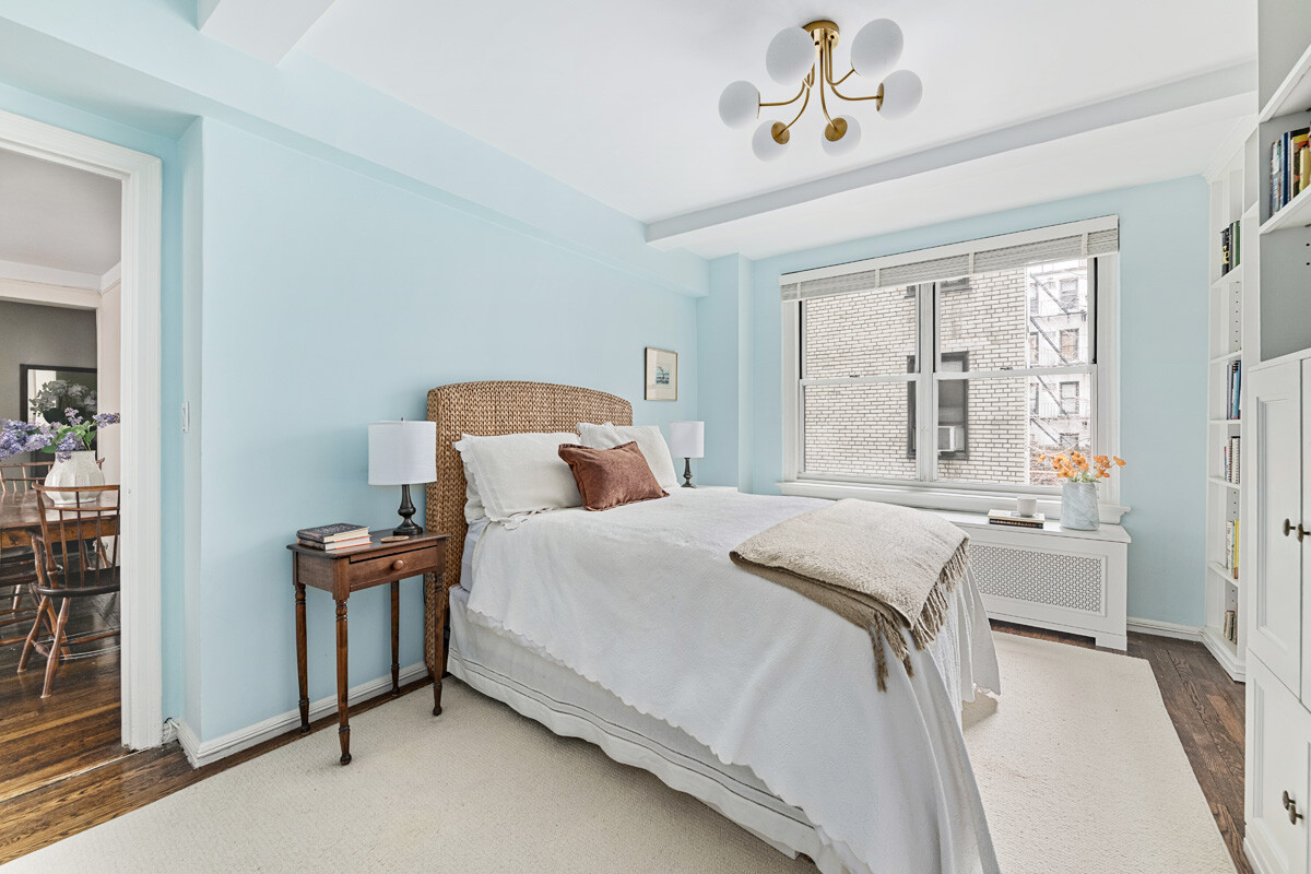 215 East 73rd Street, Unit 2A Manhattan, NY 10021 - Photo 11 of 20 a bedroom with bed and window
