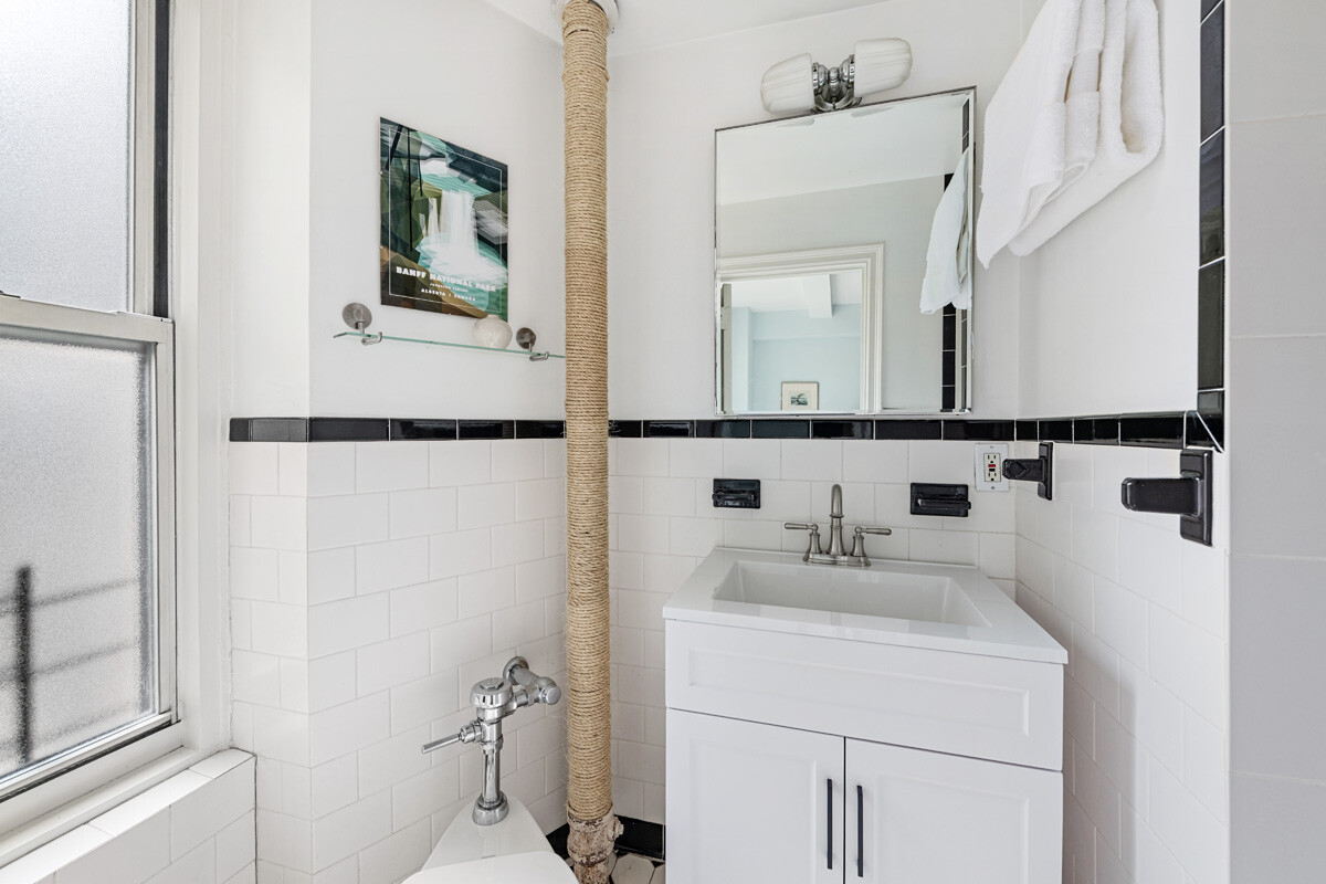 215 East 73rd Street, Unit 2A Manhattan, NY 10021 - Photo 13 of 20 a bathroom with a sink and a mirror