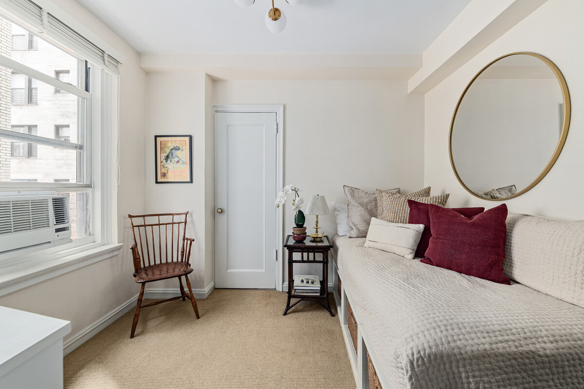 215 East 73rd Street, Unit 2A Manhattan, NY 10021 - Photo 14 of 20 a bed room with a bed and a chair