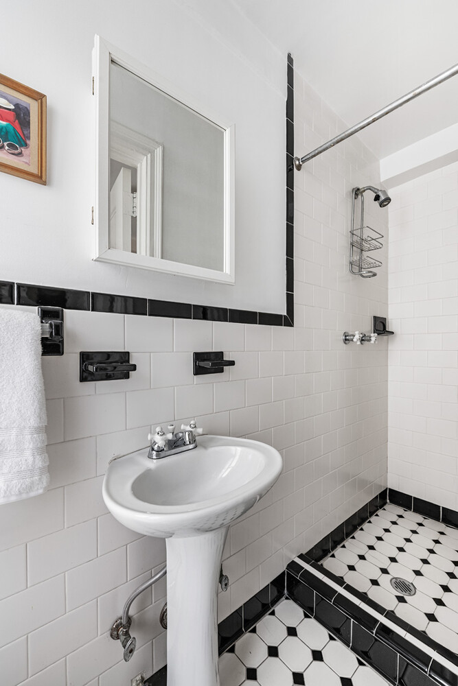 215 East 73rd Street, Unit 2A Manhattan, NY 10021 - Photo 15 of 20 a bathroom with a sink a toilet and shower
