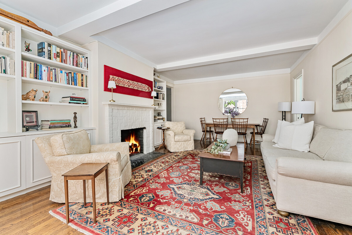 215 East 73rd Street, Unit 2A Manhattan, NY 10021 - Photo 2 of 20 a living room with furniture and a fireplace