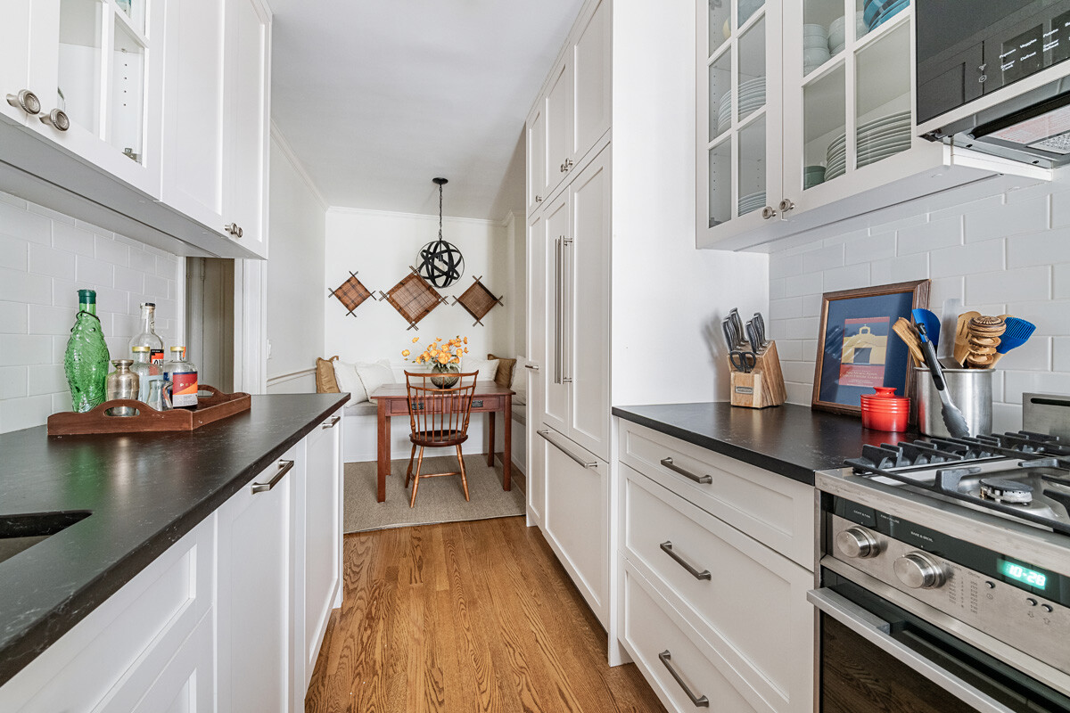 215 East 73rd Street, Unit 2A Manhattan, NY 10021 - Photo 6 of 20 a kitchen with stainless steel appliances a stove a sink and cabinets