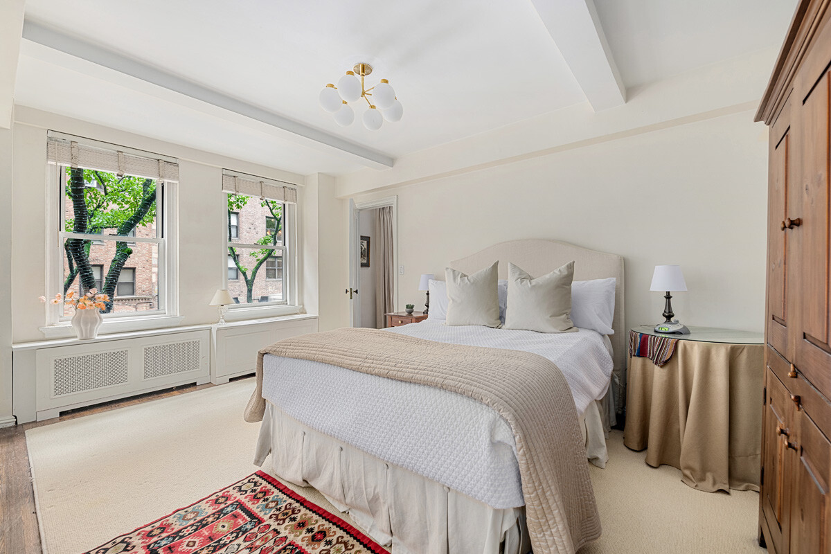 215 East 73rd Street, Unit 2A Manhattan, NY 10021 - Photo 8 of 20 a bedroom with a bed and a large window