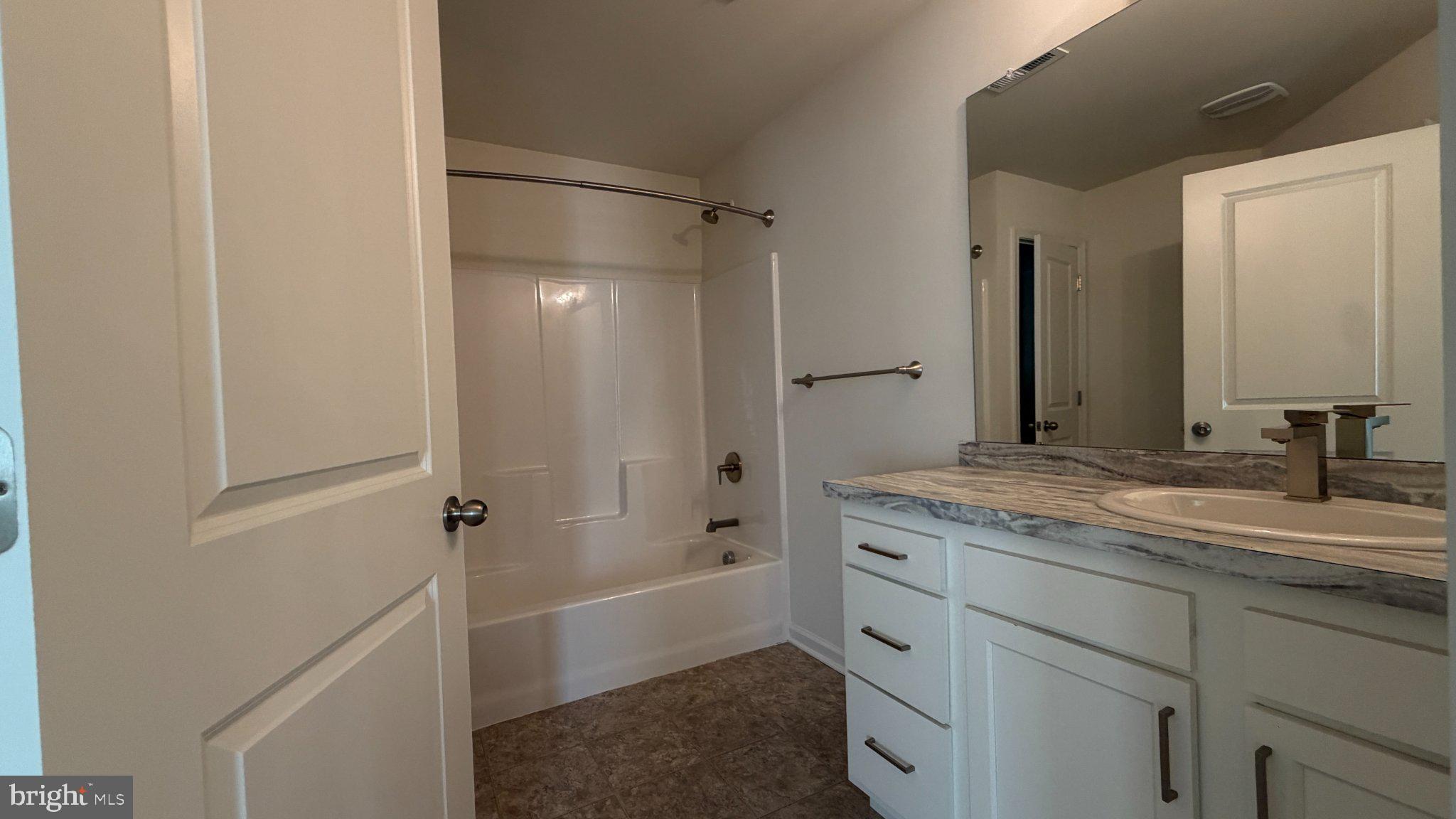 78 Tansboro Road Berlin, NJ 08009 - Photo 34 of 41 a bathroom with a granite countertop sink a mirror a shower and a bathtub